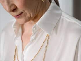Mature woman wearing a silky white shirt
